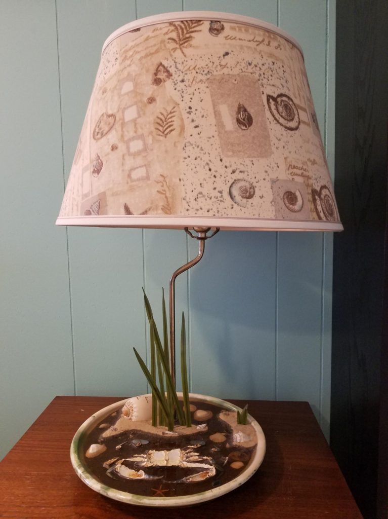Lamp with shells and other beach remnants glued into base, from furniture consignment store