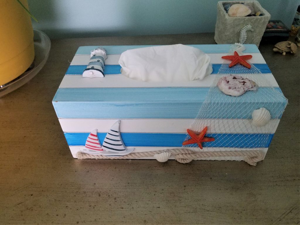 A nautical tissue box holder disguises an otherwise boring tissue box