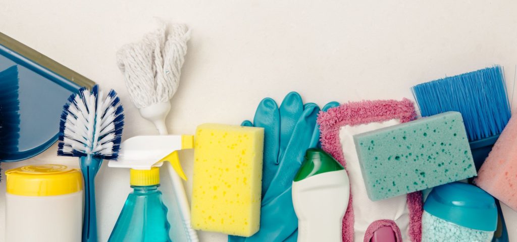 Several cleaning supplies propped against a wall. Cleaning requires both cleaning AND clearing