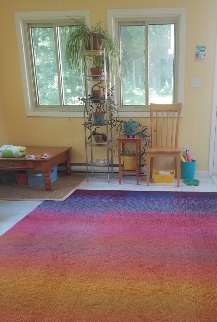 A colorful wall complements a yellow wall