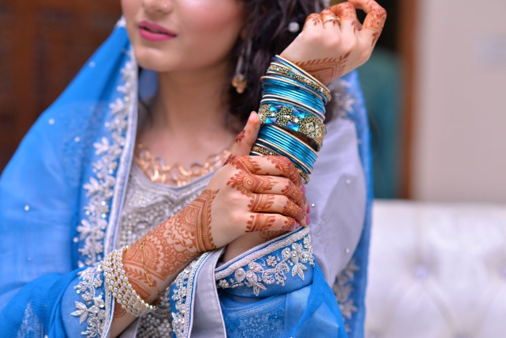 A woman in henna and bright blue traditional dress is gorgeous