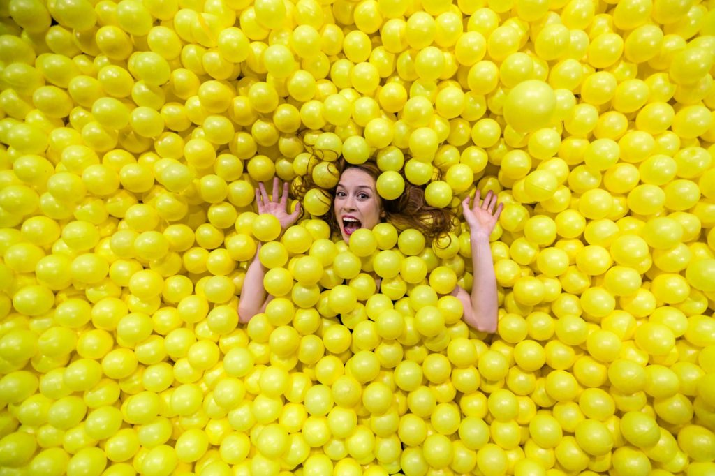 It's fun to swim in a bright yellow ball pit