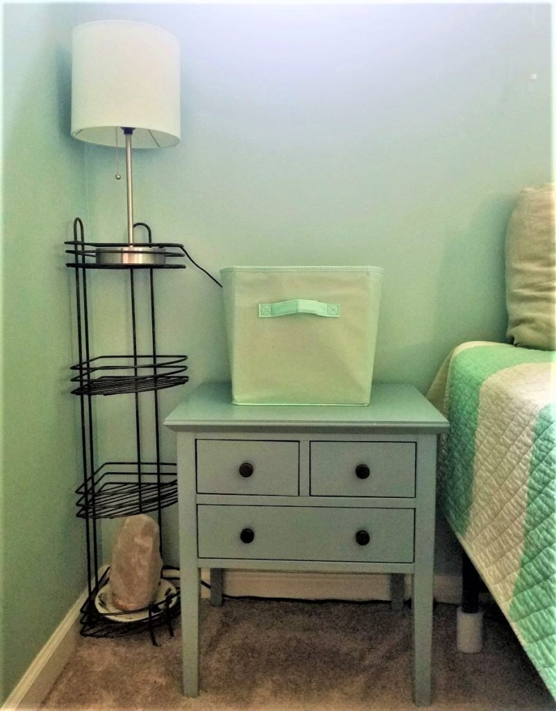 A corner lit by a simple table lamp