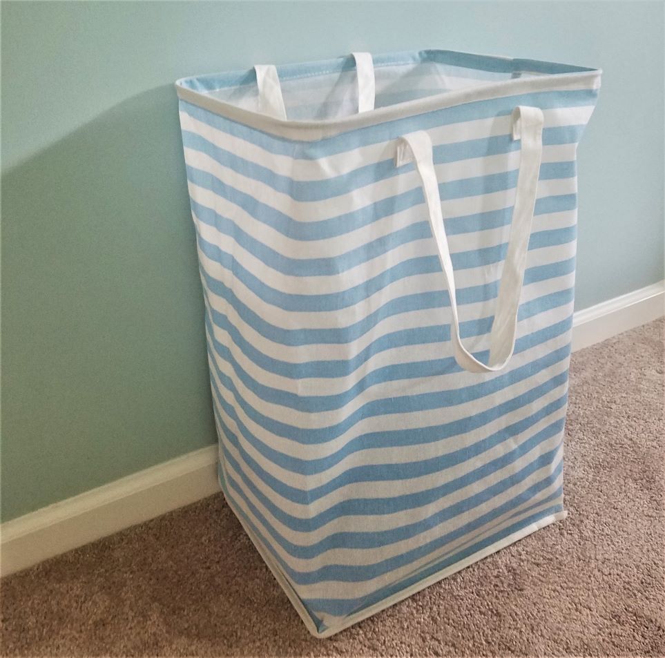 A blue and white striped hamper acts as functional decor