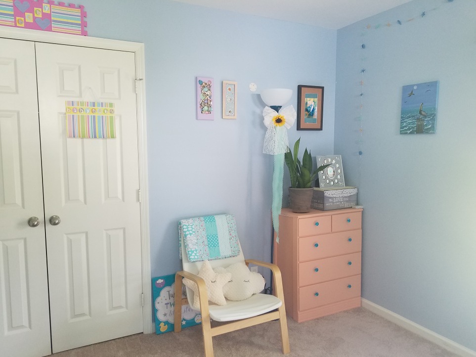 Create a calm nursery with minimal furniture and relaxing decor