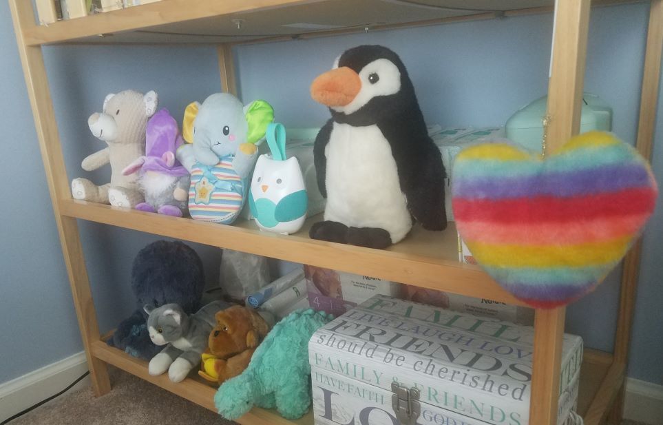 Stuffed animals on changing table shelf