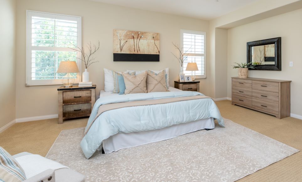 A spacious bedroom in neutral colours is calming