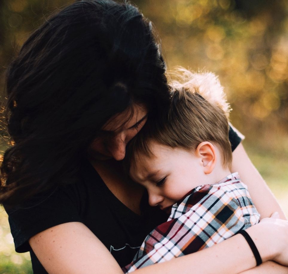 Mother embracing young son