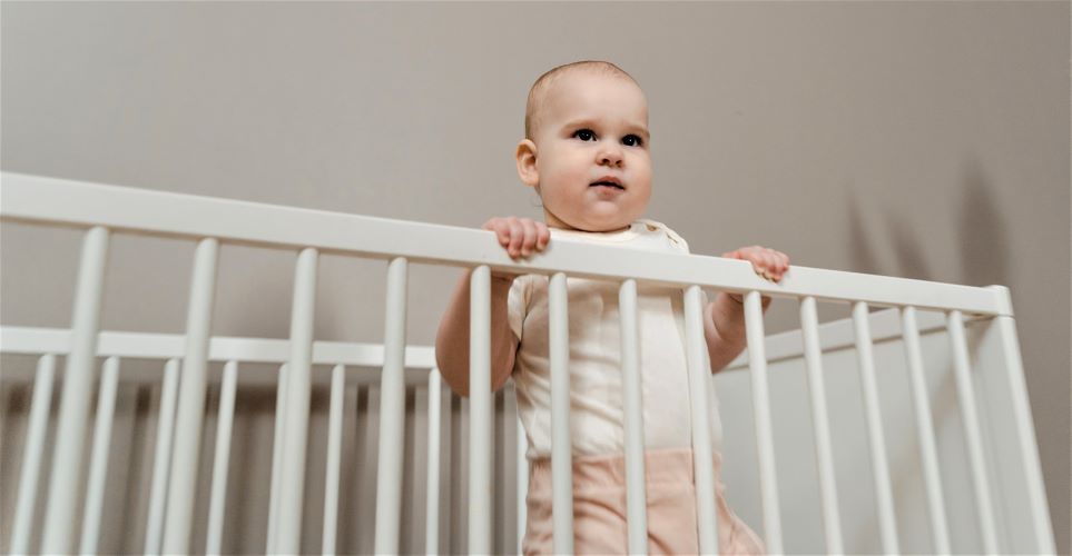 Baby standing in crib