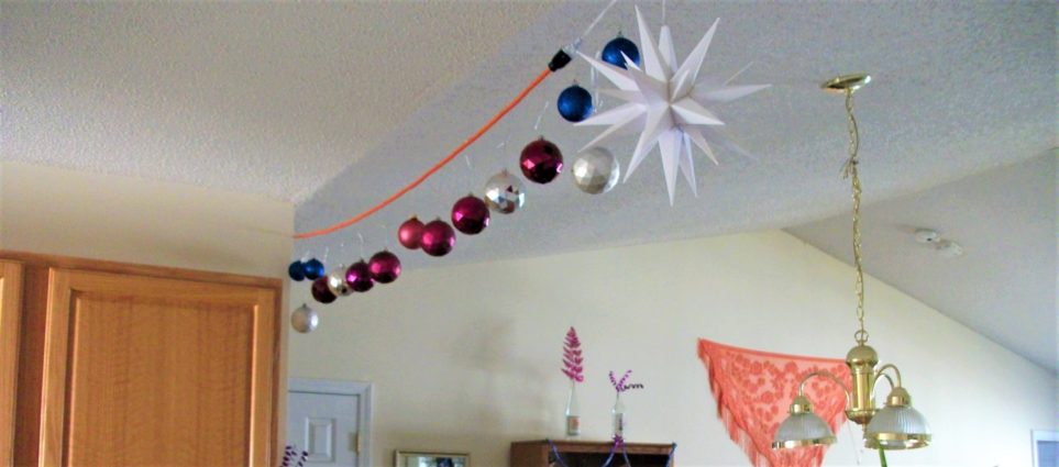 Christmas balls strung across ceiling