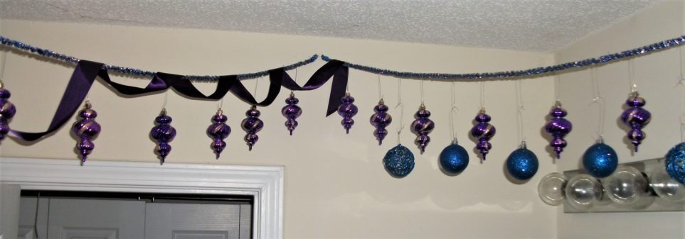 Christmas balls strung across bathroom ceiling
