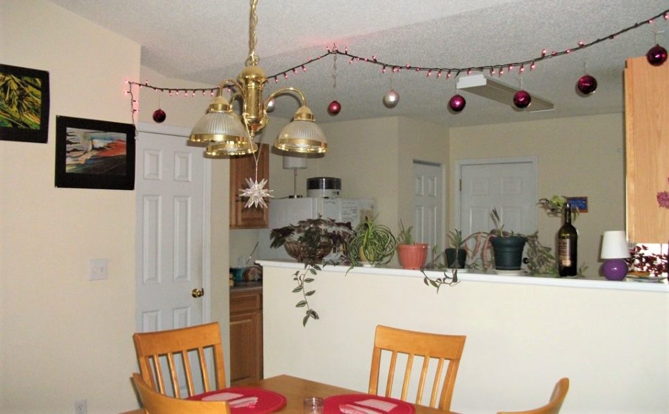 Christmas balls strung across ceiling from Christmas lights