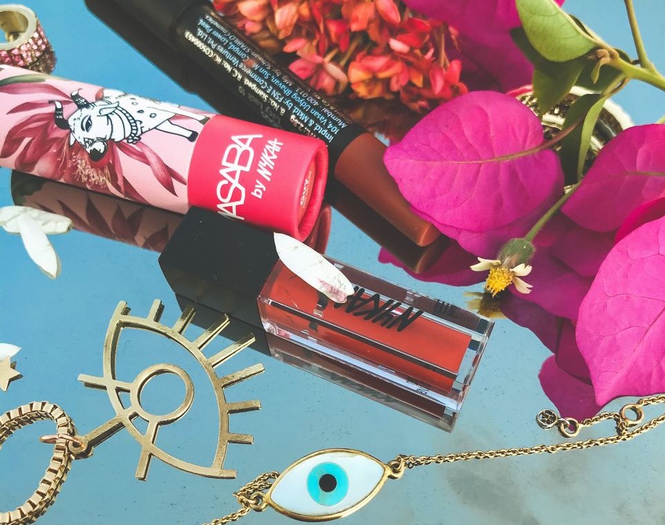 Pink flowers, pink and red cosmetics, gold eye jewelry