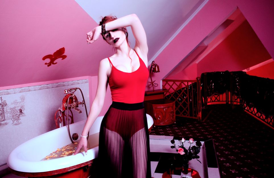 Pink room with girl in red leotard and black style accents