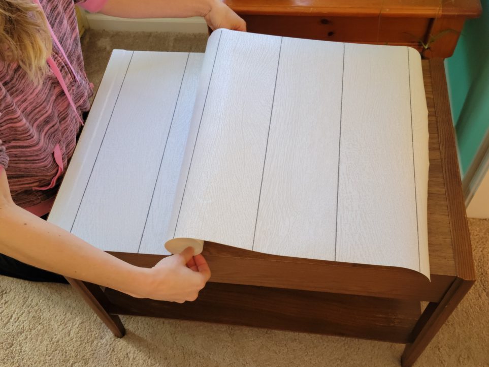 Applying shiplap peel and stick wallpaper to end table