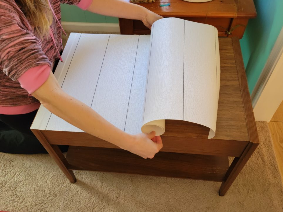 Continuing to peel back the paper backing