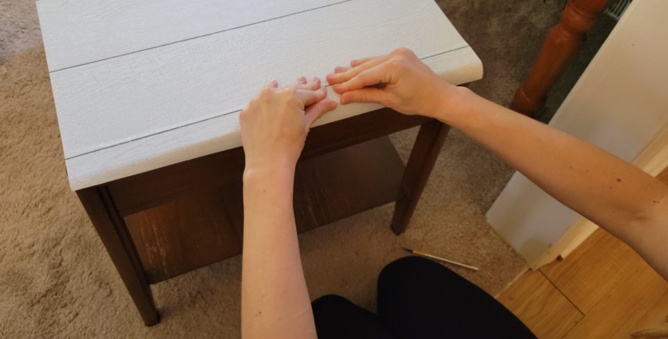 Firmly pressing paper down over edge