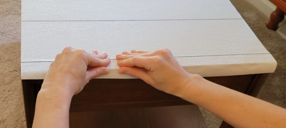 Continuing to pinch paper over edge