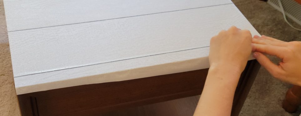 Flattening paper over edge near corner
