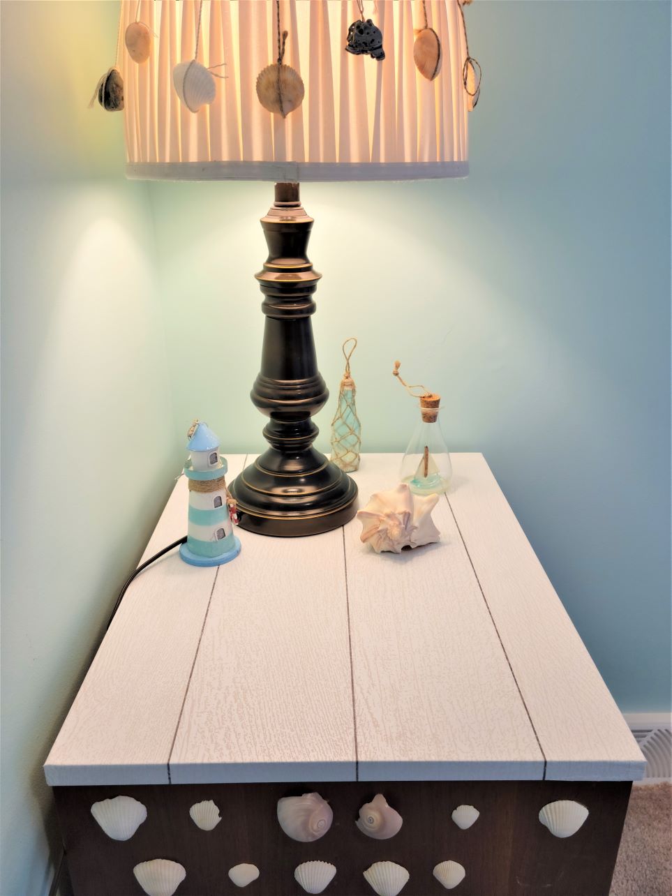 Shiplap peel and stick wallpaper applied to tabletop of end table in Captain's Quarters