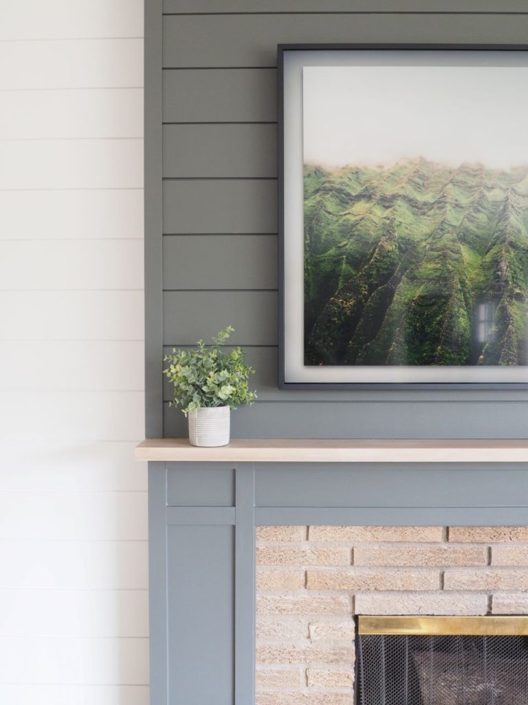 Elegant shiplap above mantel in gray and surrounding wall in white
