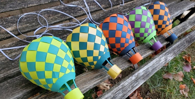Eccentric decor doesn't follow mainstream rules, like proudly displaying these chequered paper hot air balloon in personalised colour options