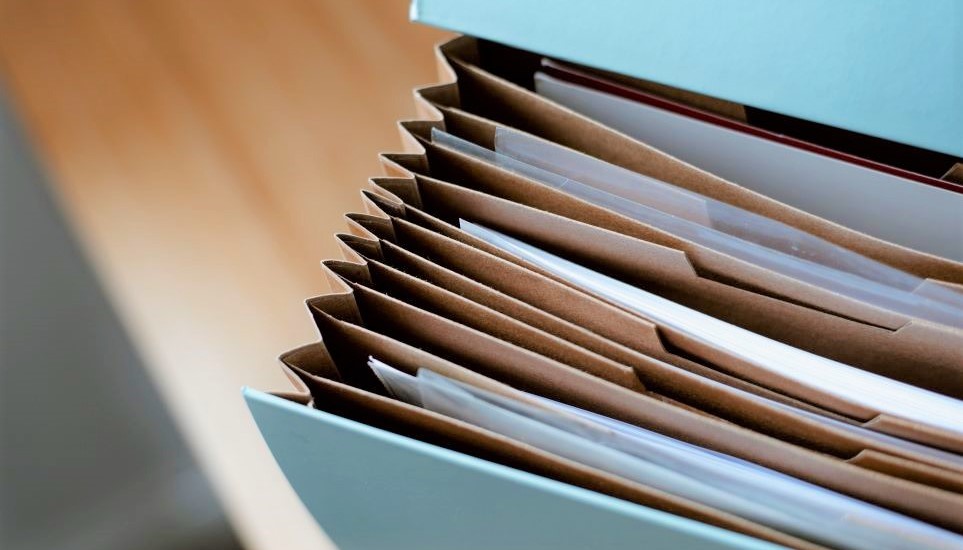 An expanding file box neatly contains organized paperwork