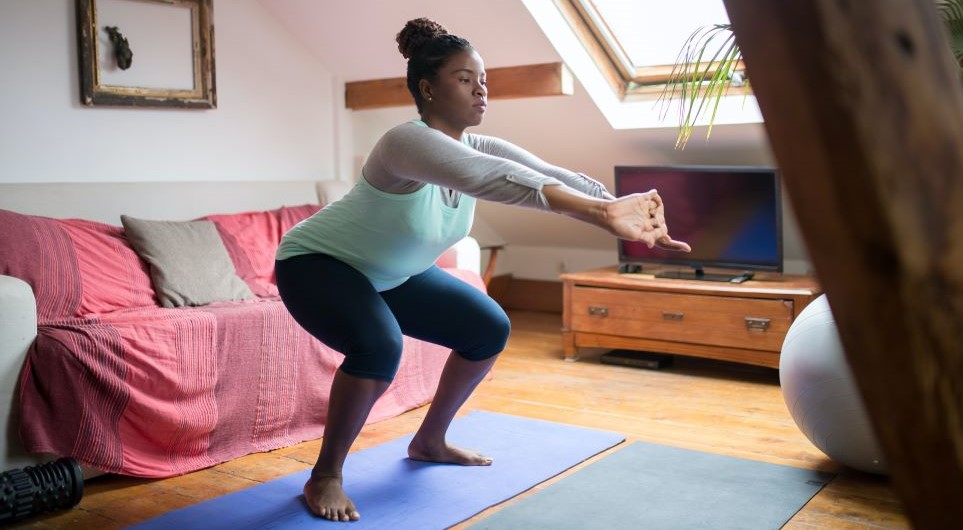 10 Minute Workout for Busy Moms: Woman squatting and stretching arms