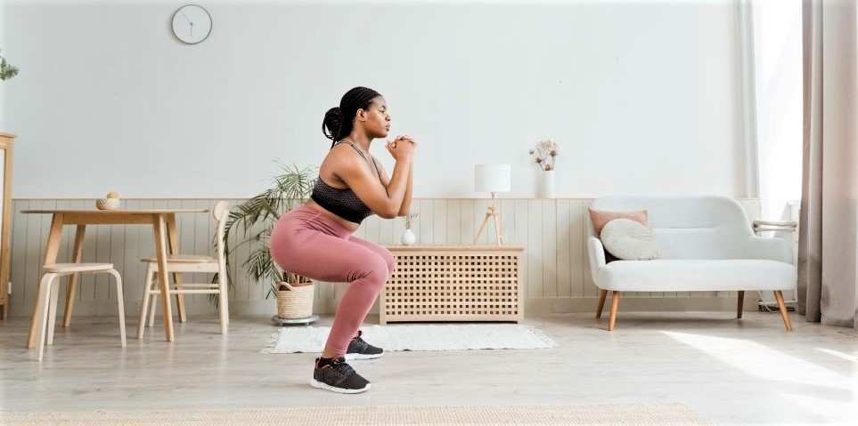 Woman doing squats workout in her home