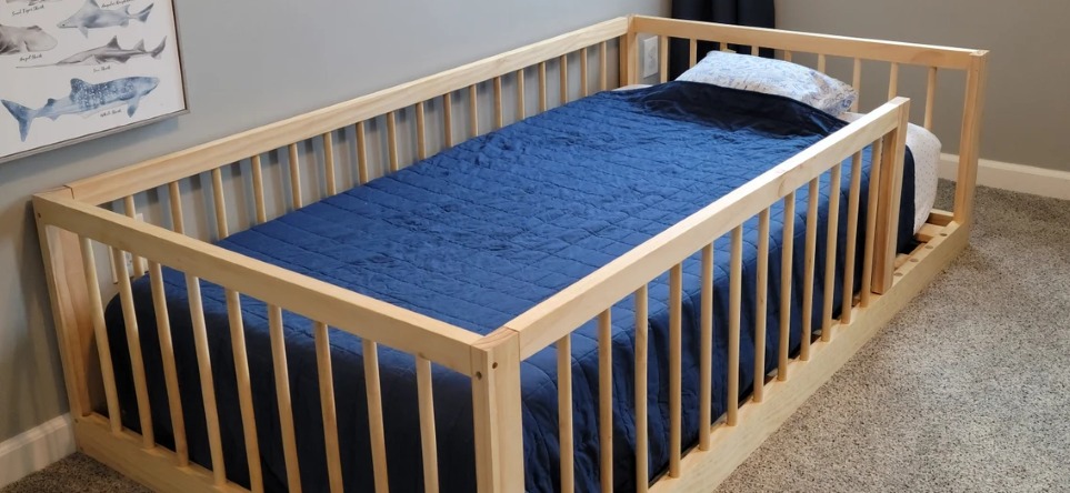 Montessori floor bed with rails and blue bedding