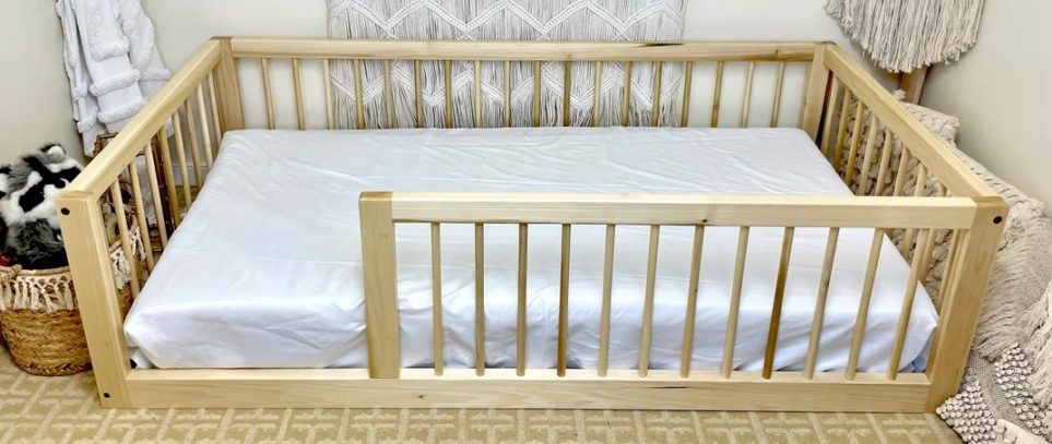 Montessori floor bed with rails and white sheet