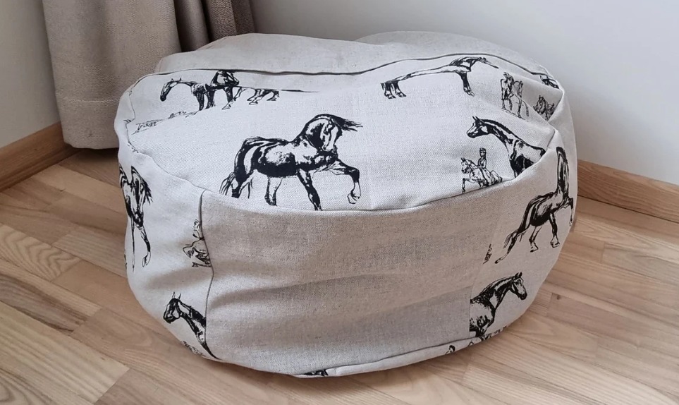Gray plush animal ottoman with horse print design