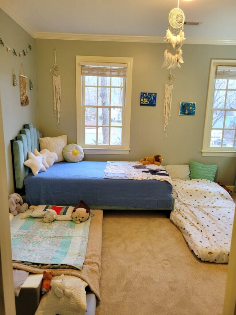On each side of the twin bed in the kindergartener's room are twin futon mattresses on the floor, each made up with sheets and blankets (because neither boy will sleep in the normal bed, and they want to share a room). Despite that, the room remains spacious and tidy enough when the beds are made, and happy decorations hang from the wall and ceiling (dream catchers, nautical decor, son's paintings, etc.)
