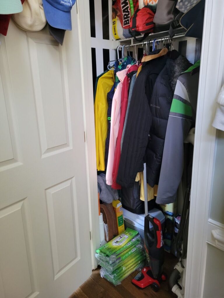Use the inside of doors to store hats by hanging them from a metal hook hung inside the coat closet door, as shown in photograph