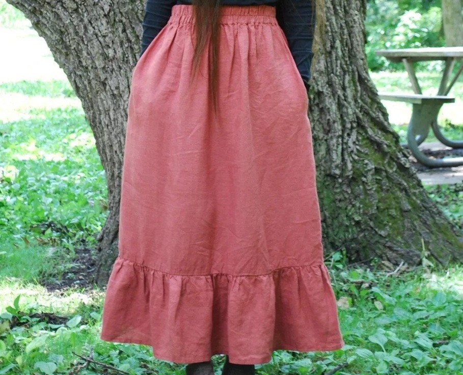 Close-up photo of salmon pink linen maxi skirt with loosely ruffled hem
