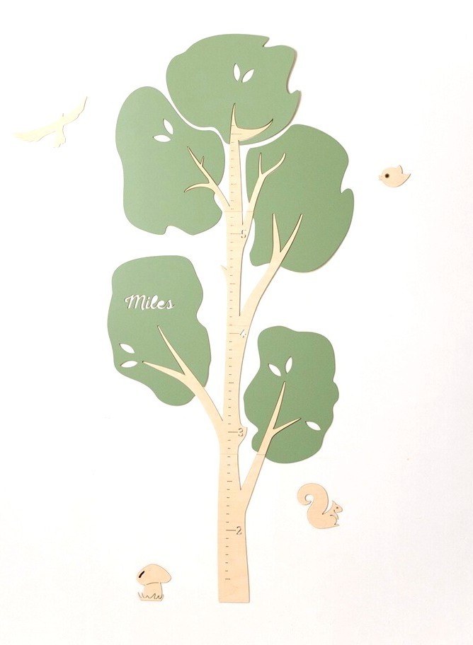 Wooden tree-shaped kids growth chart with rulered trunk and green leaves