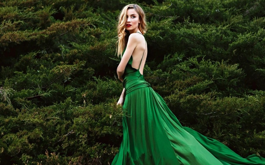 A woman models the stunning green silk dress that replicates the one worn by Keira Knightly in the film Atonement