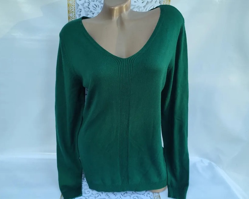 A mannequin bust wears a comfortable-looking vintage emerald green sweater