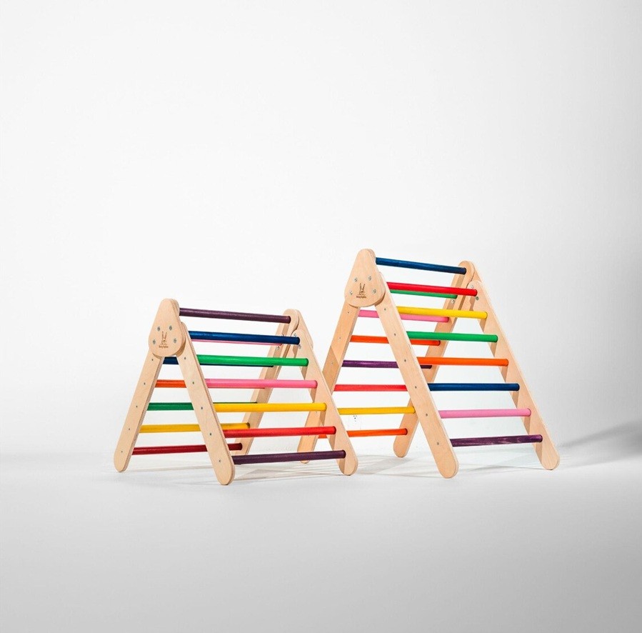 Two Pikler triangles, one slightly larger than the other, with rainbow-coloured rungs