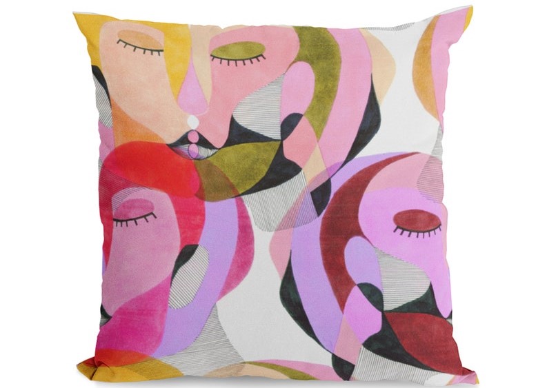 pillow with abstract feminine faces in pinks, reds, and other colors