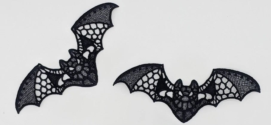 Two embroidered lacy black bats
