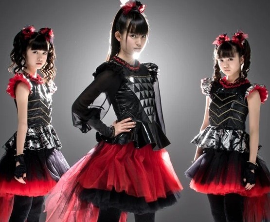 Babymetal inspires classy Halloween costumes with black and red tulle skirts, black shirts with silver/metal detailing, and red ruffles as seen in this promotional picture of the band