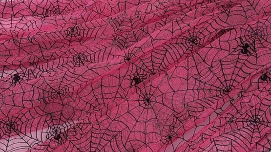 Close-up photo of bunched up hot pink spiderweb lacy tulle