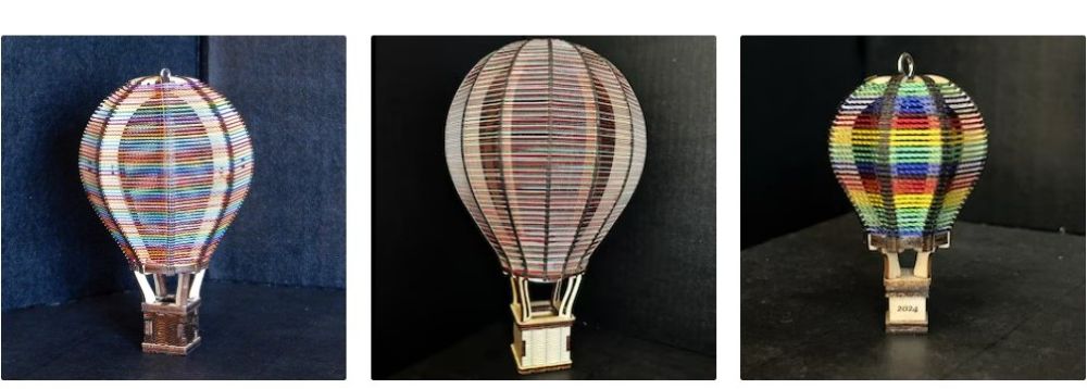 Three photos of different-coloured wooden laser-cut hot air balloons with small horizontal wooden ridges forming the balloon shape