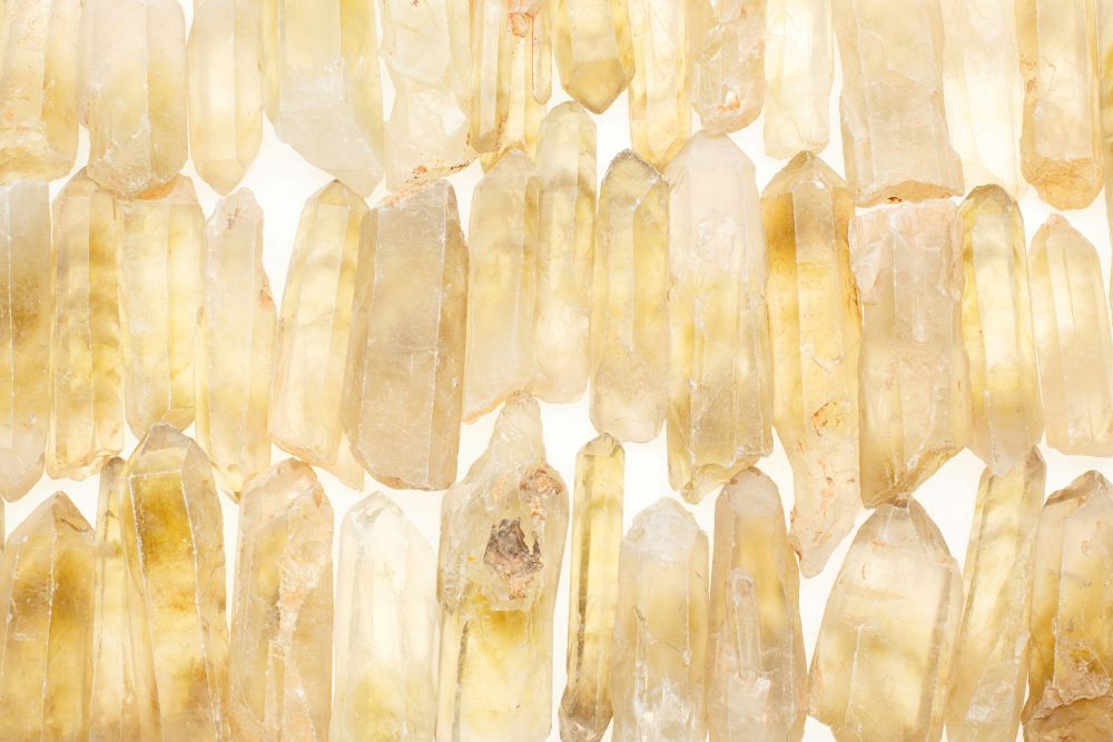 With this many citrines, you'll have plenty of crystals for each room: dozens of beautiful raw citrines are clustered together in three horizontal rows