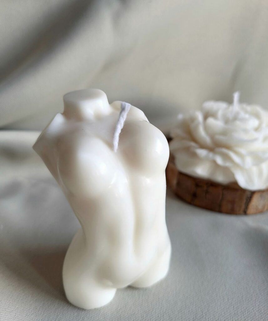 Close-up photo of a white-coloured female torso-shaped candle