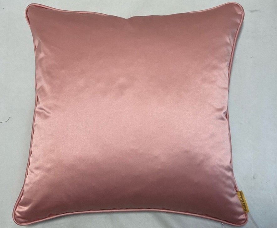 Close-up top-down photo of a square-shaped salmon pink sateen throw pillow