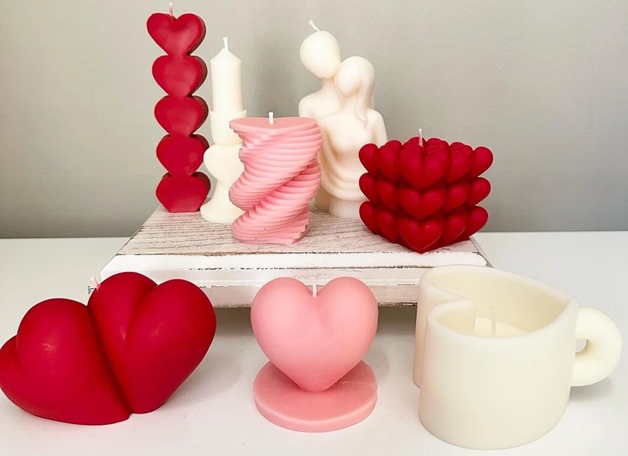 Eight uniquely shaped candles in cream, pink or red, in different lovecore-themed heart shapes