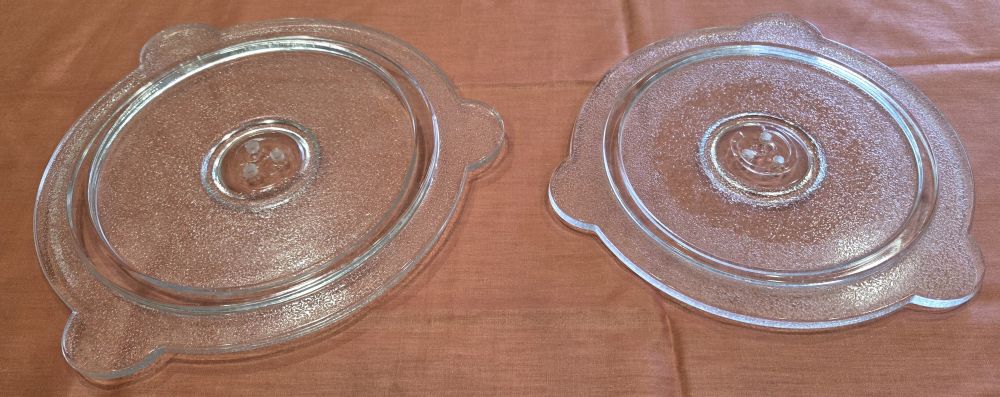 These non-toxic glass microwave splatter covers are great household products if you reheat leftovers or frozen meals in the microwave but don't want to clean up the occasional food splatter. The two shown are round with three tabs on each, made of non-toxic frosted glass