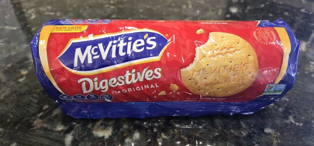 An unopened roll of McVitie's brand plain digestives atop a kitchen counter